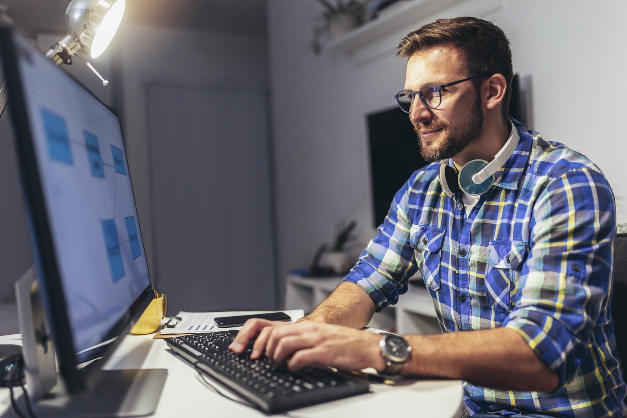 Man working on computer in garage office
