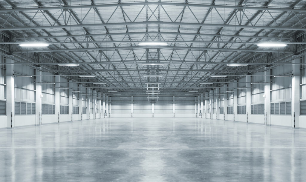 Empty factory with concrete floor, night scene