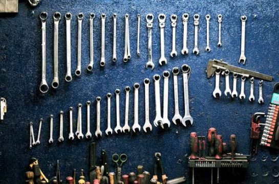 A collection of tools hanging on a wall