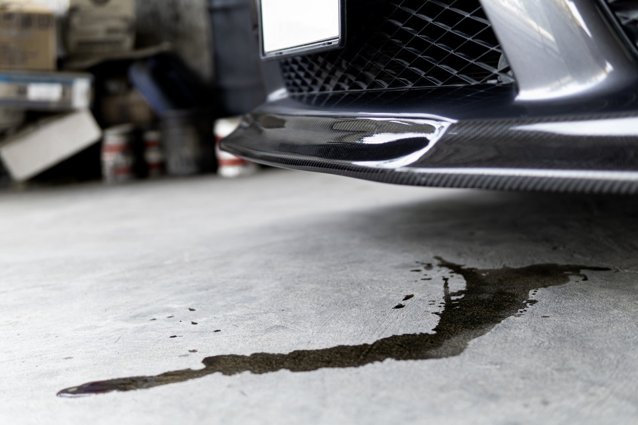 Engine oil stains of car Leak under the car when the car is park on the road service photo concept for check and maintenance